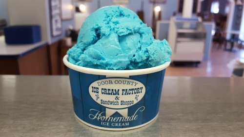 A blue scoop of ice cream in a cup from Door County Ice Cream Factory & Sandwich Shoppe.
