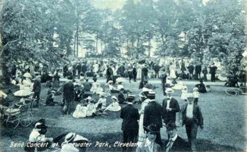 A vintage photo of a large crowd enjoying a band concert at Edgewater Park in Cleveland, with people in period attire.