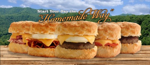 Three delicious breakfast sandwiches on a wooden table, with a scenic mountain backdrop and the text "Start Your Day the Homemade Way."