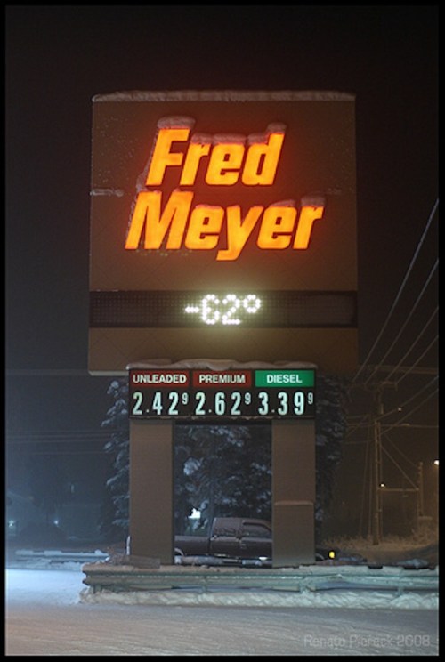 Sign for Fred Meyer displaying fuel prices: Unleaded $2.42, Premium $2.62, Diesel $3.39, with a temperature of -62°F.