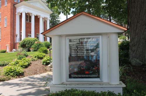 Signboard displaying the summer concert series schedule at a venue, featuring various artists and dates.