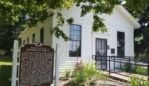 Historic white building with a sign reading "Birthplace of Republican Party" and a plaque detailing its history.