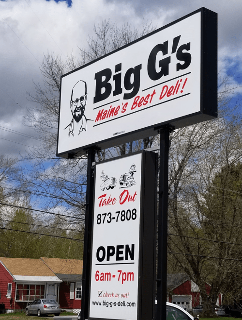 Sign for Big G's Deli in Maine, featuring "Maine's Best Deli!" and hours of operation, with a takeout number.