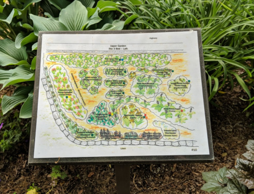Map of the Upper Garden, detailing plant beds and pathways, surrounded by lush greenery.
