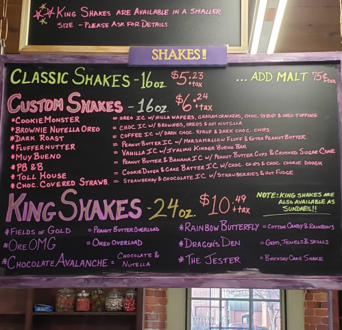 Menu board featuring various milkshake options, including classic, custom, and king shakes with prices listed.
