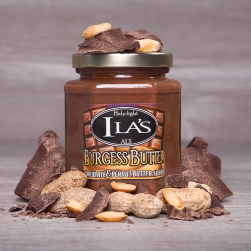 A jar of Burgess Butter chocolate and peanut butter spread, surrounded by peanuts and chocolate pieces.