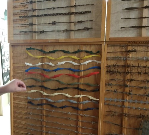 A display board featuring various colored and shaped arrows and spear points arranged in rows.