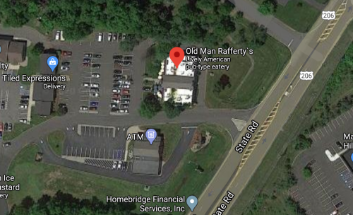 Aerial view of Old Man Rafferty's, a lively American pub-type eatery, near a parking lot and State Road.