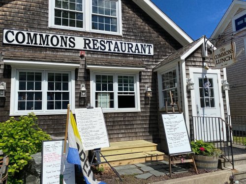 Exterior of Commons Restaurant with wooden shingles, menu boards outside, and a sign for The Commons Lunch.