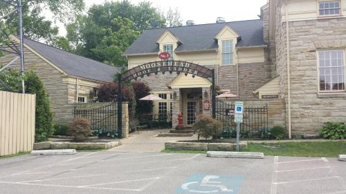 Entrance of the Moosehead Hotel and Ladder, featuring stone architecture and outdoor seating.