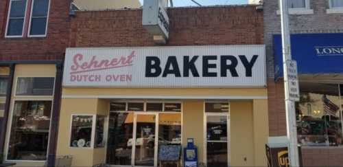 Sign for "Sehnert Dutch Oven Bakery" on a storefront, featuring large black letters on a white background.