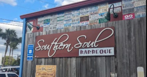 Exterior of Southern Soul BBQ on St. Simons Island, GA. A rustic wooden building with a custom sign.