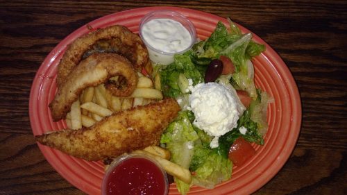 A plate with fried fish, French fries, a side salad, and dipping sauces.