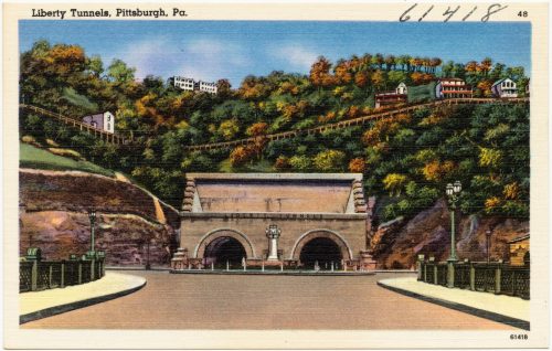 Vintage postcard of the Liberty Tunnels in Pittsburgh, featuring tunnel entrances and hillside homes in autumn colors.
