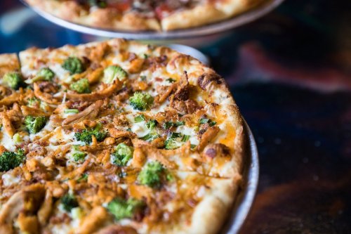 Close-up of a delicious pizza topped with vegetables, served on a plate.