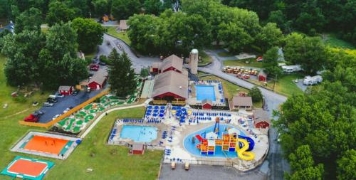 Aerial view of a recreational area featuring pools, water slides, mini-golf, and surrounding greenery.