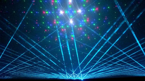 A vibrant display of colorful laser beams radiating from a central point against a dark background.