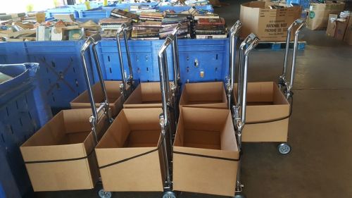 Empty cardboard boxes on wheeled carts, with stacks of books in the background.
