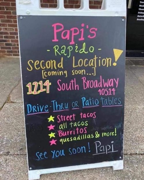 Sign for Papi's Rapido announcing a second location with details on drive-thru and patio tables, featuring menu items.