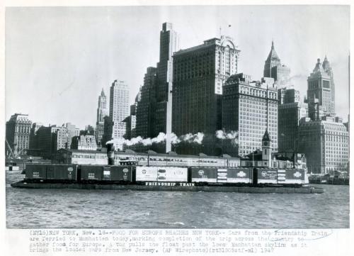 Black and white photo of the Friendship Train arriving in New York, with Manhattan skyline in the background.