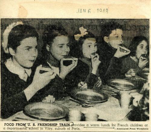 Children at a school in Vitry, France, enjoy a warm lunch provided by the U.S. Friendship Train, January 6, 1948.