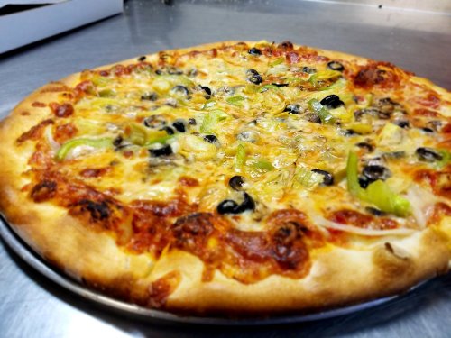 A freshly baked pizza topped with cheese, olives, green peppers, and a rich tomato sauce on a golden crust.