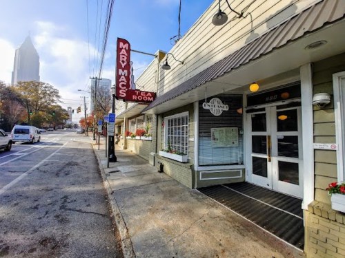 Exterior of Mary Mac's Tea Room, featuring a sign and a sidewalk view in an urban setting.