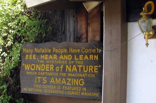 Sign promoting a natural geyser, highlighting its appeal and features in National Geographic and Sunset Magazine.