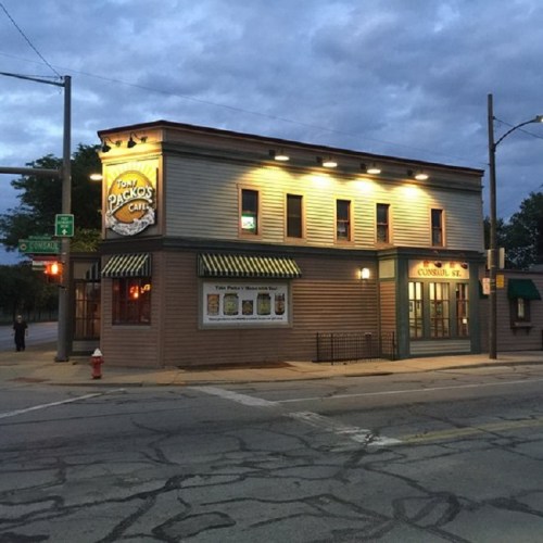 A corner view of a cafe building with a sign reading "Tony Packo's Cafe," under a cloudy evening sky.