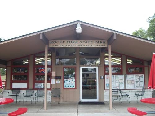 Front view of the Rocky Fork State Park camp registration and concession building, featuring large windows and outdoor seating.