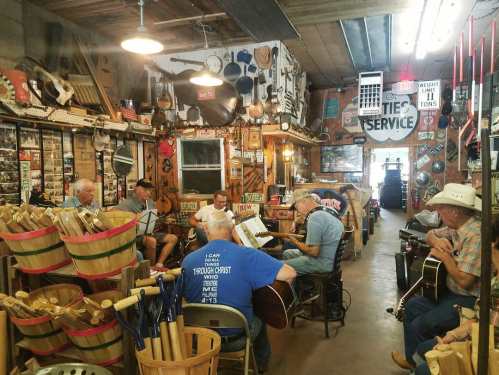 A group of musicians playing instruments in a rustic workshop filled with vintage decor and tools.