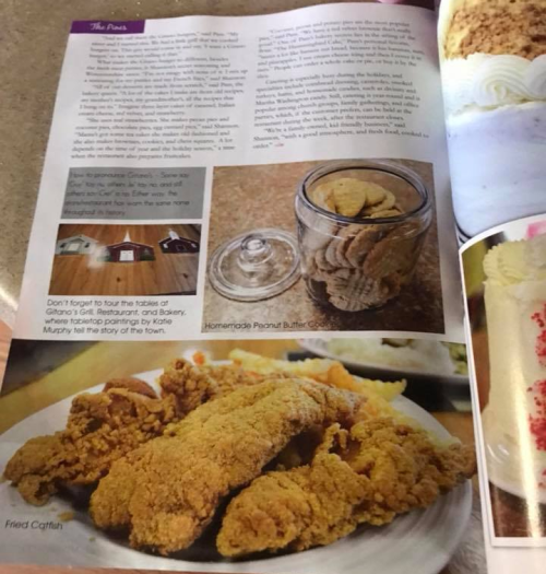 A magazine page featuring fried catfish and a jar of homemade peanut butter cookies, with text about local dining.