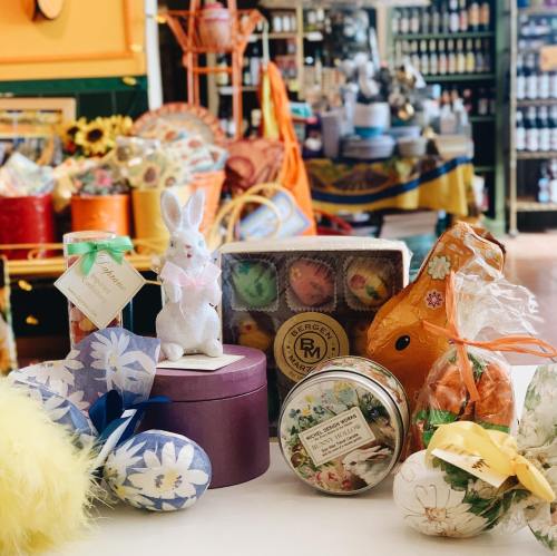 A colorful display of Easter-themed treats, including decorative eggs, a bunny figurine, and gift boxes.
