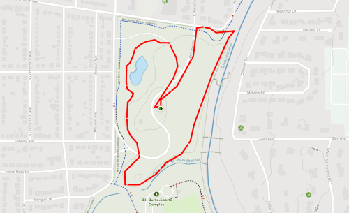 Map showing a park layout with a marked trail highlighted in red, surrounded by residential areas.