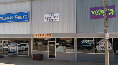 Storefronts featuring "Williams Paints," "The Rare Find Antiques," and "Yogi's Vape," with an open sign visible.