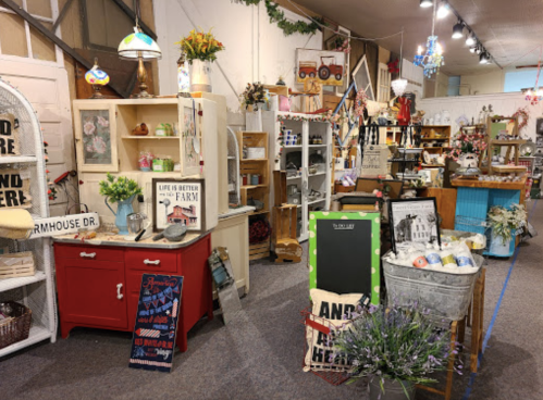 A cozy vintage shop filled with rustic decor, furniture, and farmhouse-themed items.