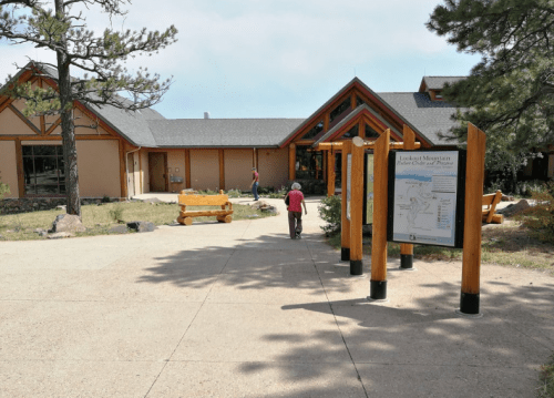 A visitor center at Lory State Park, with a path leading to the entrance and a map display in front.