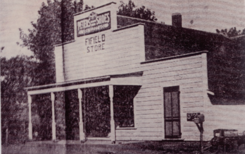 Historic black-and-white photo of the Fifield Store, featuring a simple wooden facade and porch.