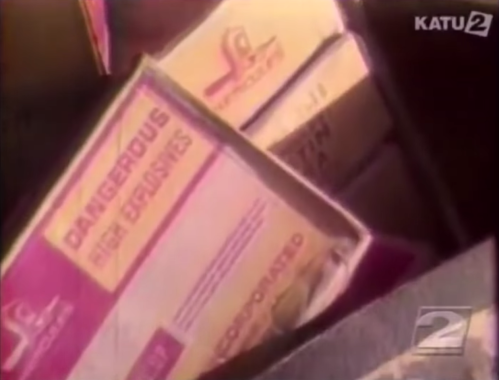 Boxes labeled "DANGEROUS FIRE BRUSHES" and other items, partially visible in a cluttered setting.