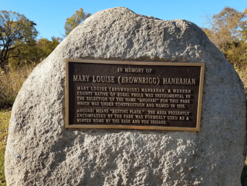 Plaque on a rock honoring Mary Louise Hanrahan, detailing her contributions and the park's history.