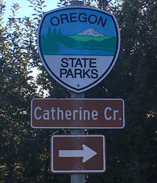 Oregon State Parks sign with a scenic design, indicating Catherine Creek with a right arrow.