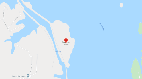 Map showing Graveyard Island located in a lake, with surrounding water and nearby land features.
