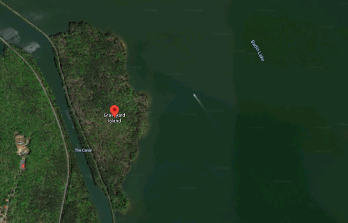 Aerial view of Graveyard Island surrounded by water, with nearby features labeled as The Canal and Bait Lake.