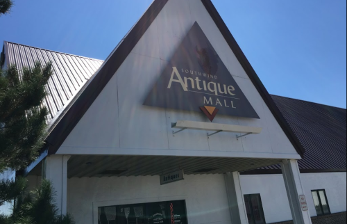Exterior of Southwind Antique Mall with a clear blue sky and sunlight shining on the building.