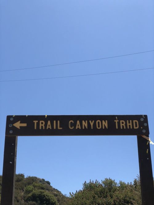 Sign for Trail Canyon Trailhead with clear blue sky in the background.