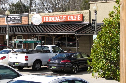 Exterior of Irondale Cafe with parked cars in front and a clear blue sky above.