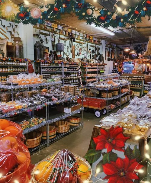 A cozy market filled with shelves of jars, candies, and festive decorations, creating a warm holiday atmosphere.