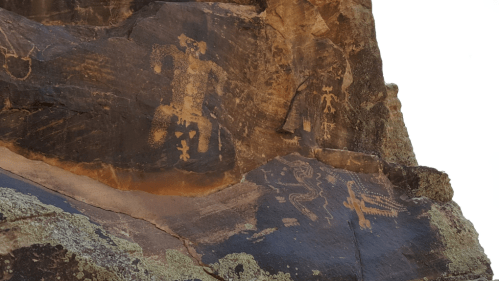 Ancient petroglyphs on a rocky surface, depicting human figures and animals in earthy tones.
