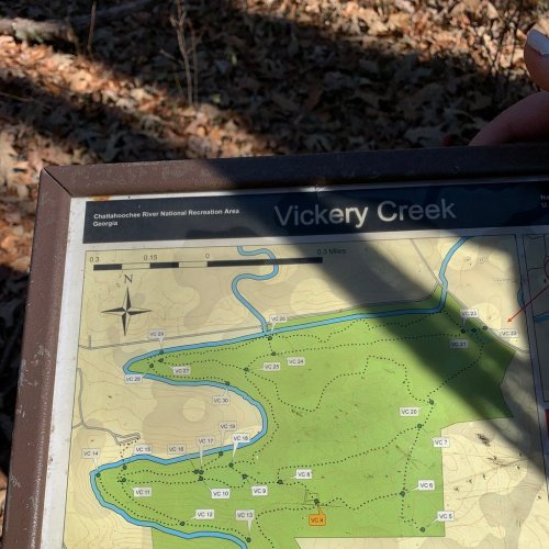 A hand holds a map of Vickery Creek in the Chattahoochee River National Recreation Area, showing trails and terrain.