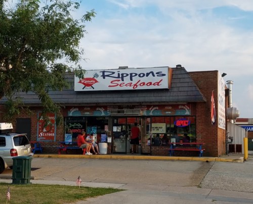 A seafood restaurant named "Rippon's Seafood" with an open sign, featuring outdoor seating and a casual atmosphere.